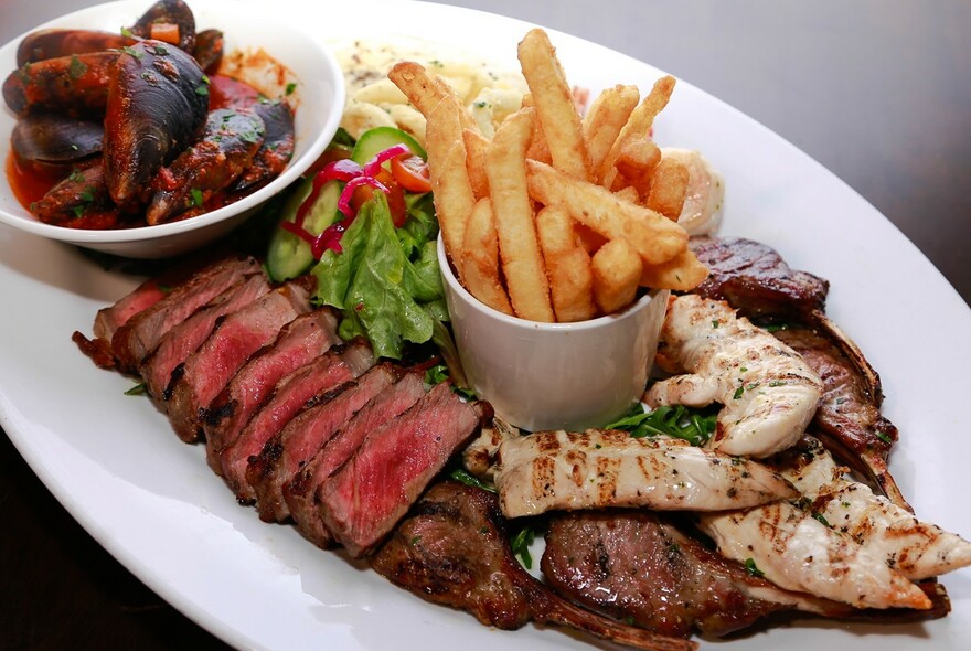 Platter with chips, meat and salad.