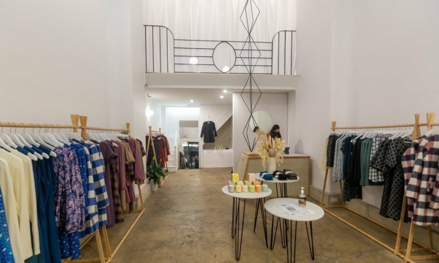 A boutique with geometric sculptures and women's clothing.
