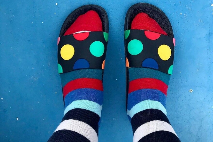 Brightly-coloured, stripy socks and sandals with coloured dots.