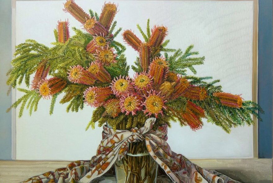Still life painting of a vase of orange banksias with patterned fabric.