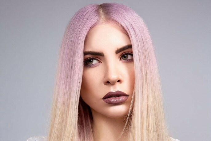 Woman with pink hair that fades to blonde at the ends. 