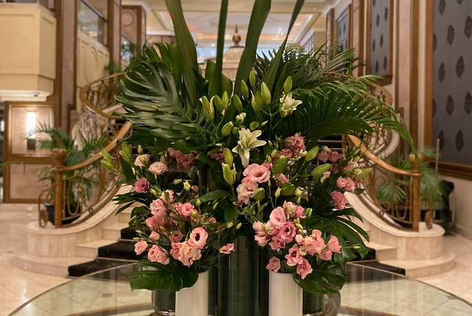 A grand floral arrangement in a marble foyer.
