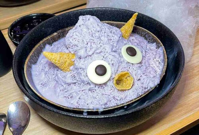 A purple dessert designed to look like a cute cartoon monster.