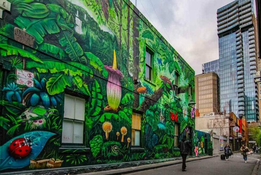 A large green floral street art mural