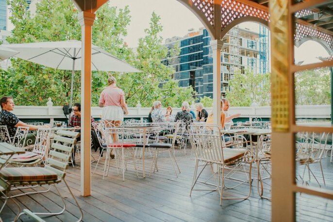Staff and customers on the deck at Madame Brussels.