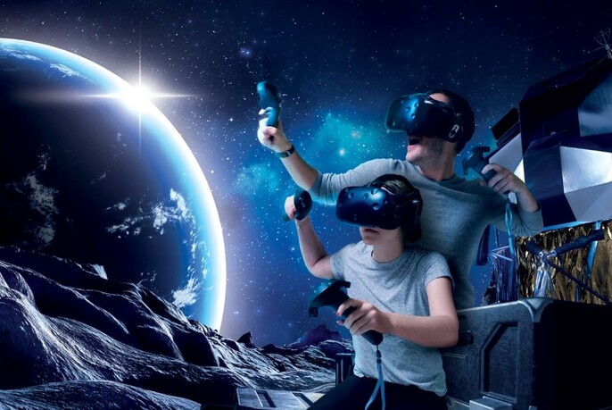 Two people wearing virtual reality head gear with a background scene of planet earth.