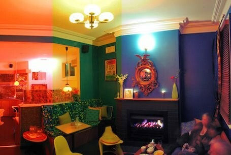 Brightly-coloured cosy bar setting with dark blue walls.