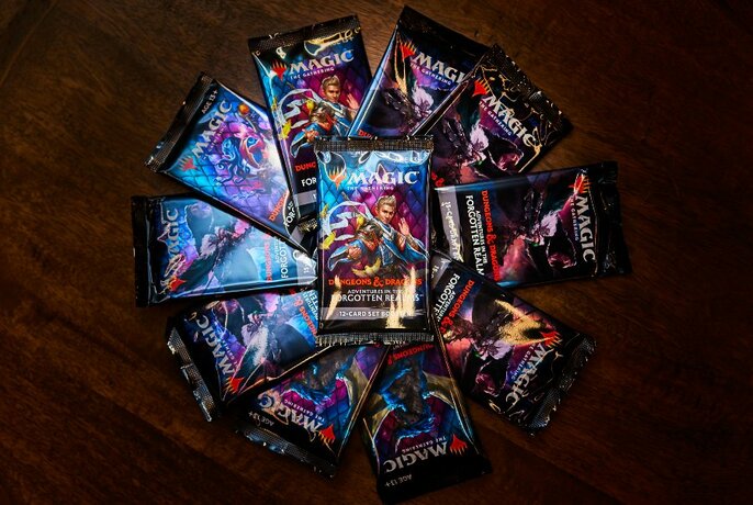 Array of card packs on dark table, seen from above.