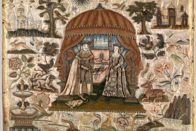 Small and detailed embroidery of two figures in Medieval garb, under a canopy.