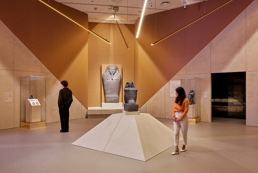 Two people are in an Egyptian exhibition