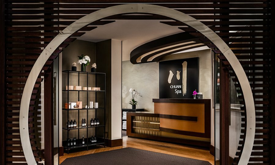 A day spa with a circular wooden entry and products on shelves.