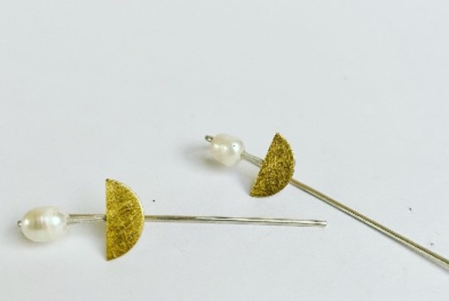 Freshwater pearl and gold jewellery on a white background.