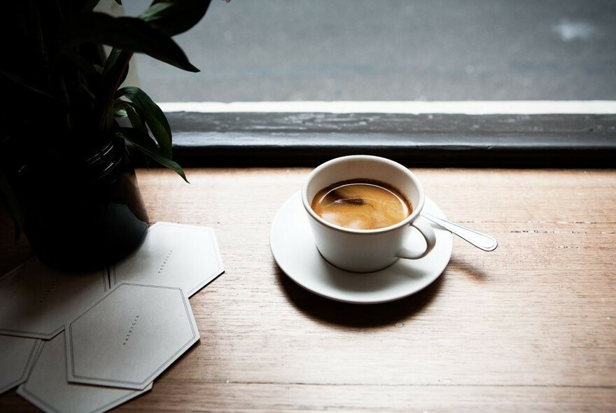 Cup of coffee on a windowsill. 