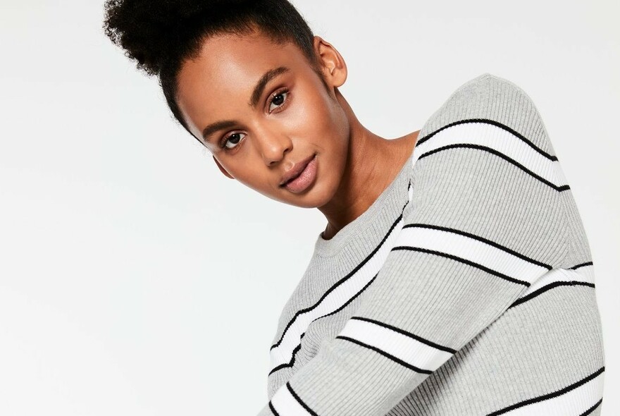 Model in grey top with white and black stripes.