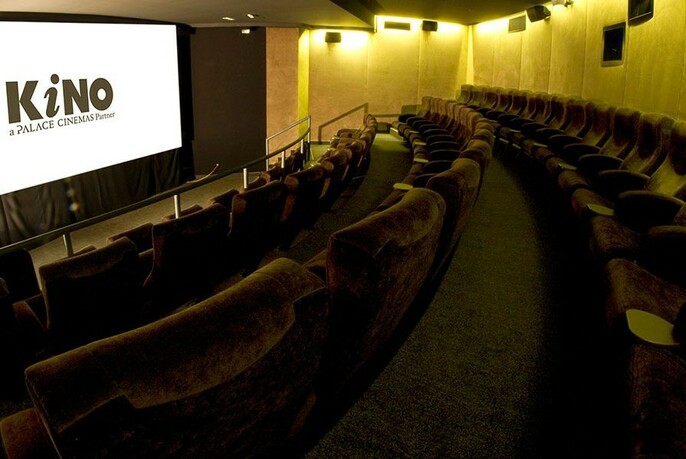 Tiers of seating and cinema screen inside the Kino.