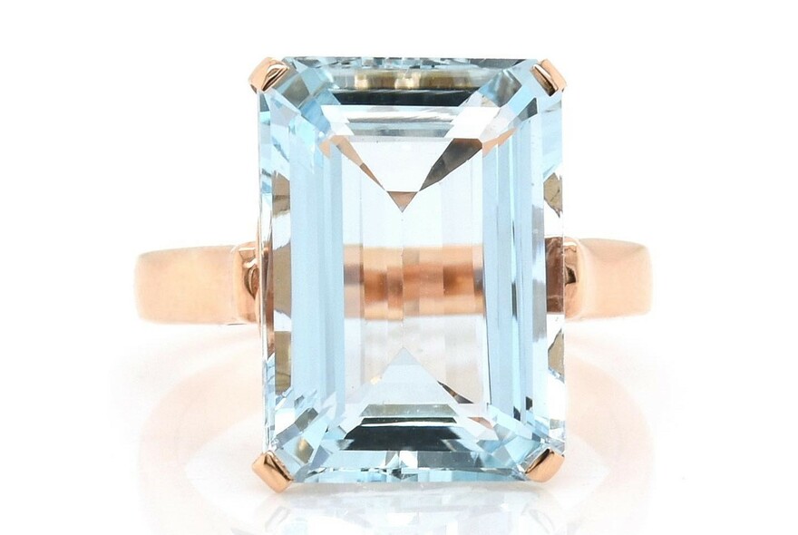 Rose gold ring with large blue crystal.