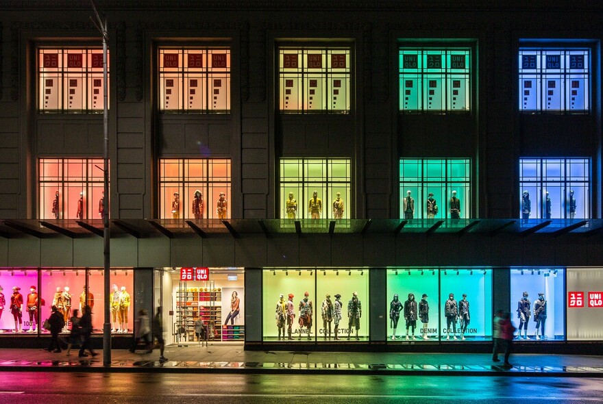 Uniqlo exterior featuring pink, orange, yellow, green and blue windows over three storeys.