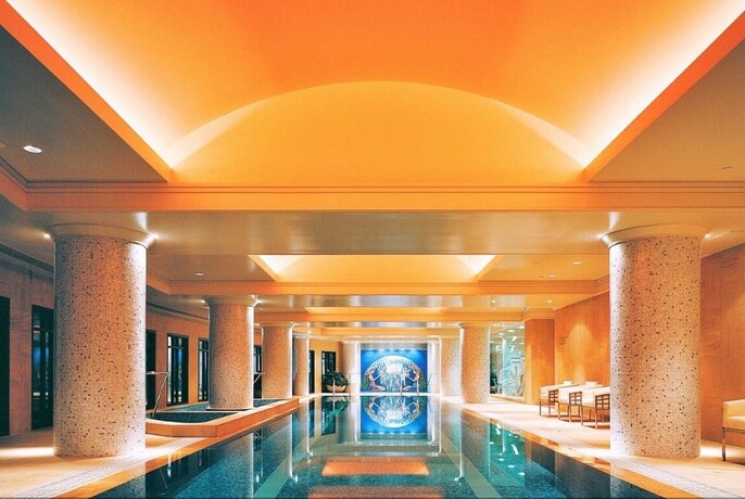 Interior of Park Club Health & Day Spa showing a pool and marble columns. 