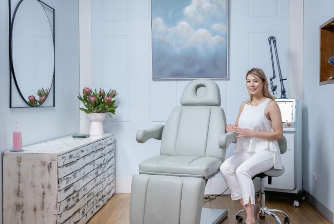 Person seated in a skincare salon.