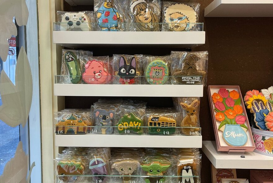 Interior of The Confectionist Bakery store showing a shelf filled with packaged decorated cookie products.