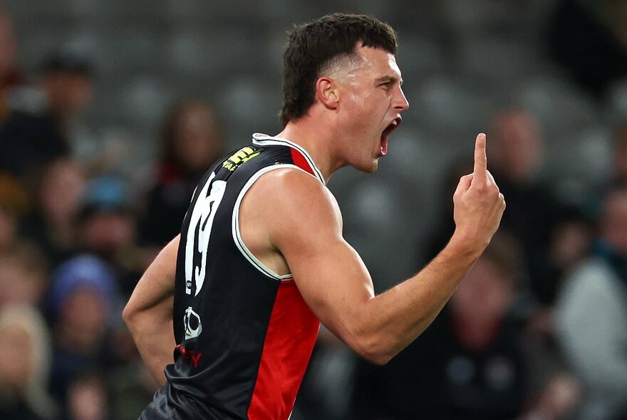 A St Kilda AFL football player pointing a finger and screaming during a match.
