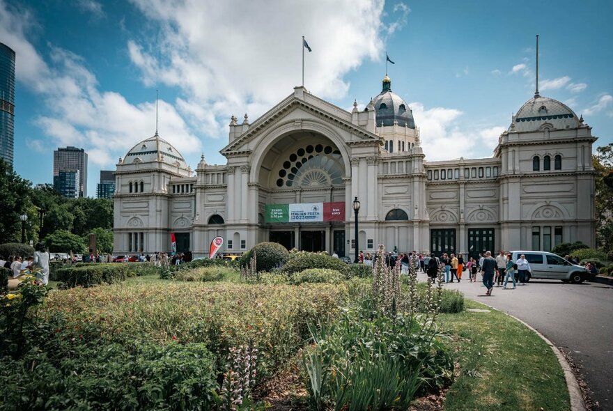 Royal Exhibition Building front facade with central entrance and flowerbeds.