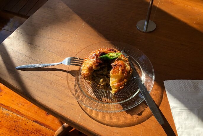 A pie cut open sitting on a sunny table
