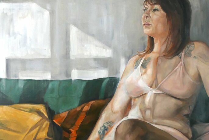 Oil painting of a woman wearing a bikini top, seated on a green couch and looking to the side, shadows on the white wall behind her.