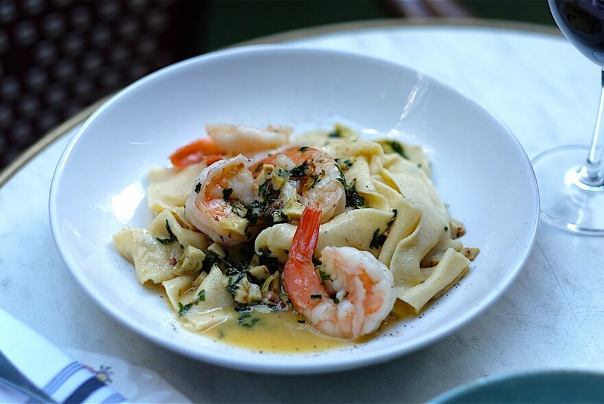 A dish of pasta and prawns.