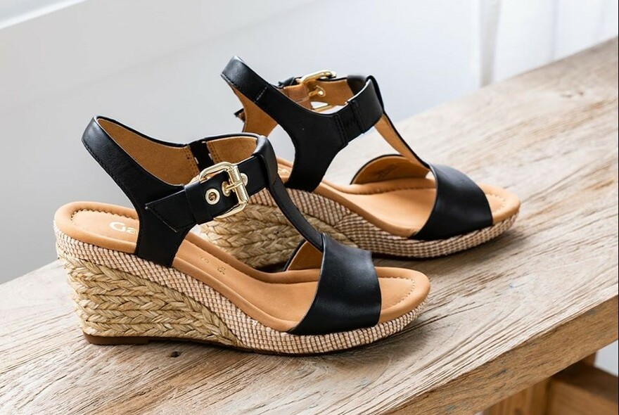 Pair of women's sandals with high, wedge heel.