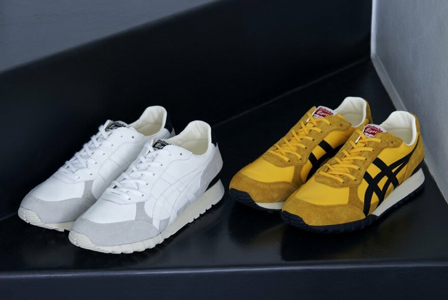 Two pairs of Onitsuka Tiger shoes, white and yellow.
