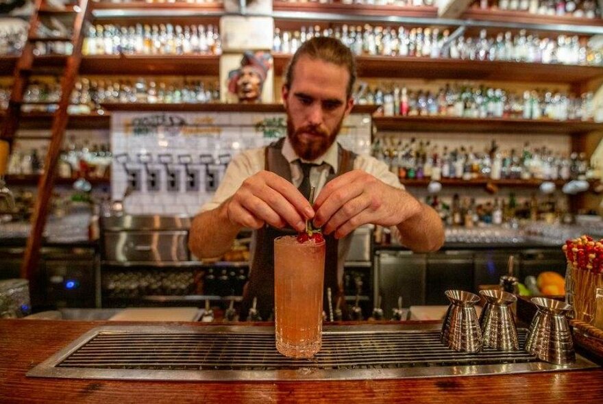 A bartender mixing a drink.