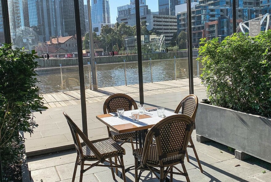 Waterside table and seating at Plus 5 Bar and Restaurant, beside the Yarra River.