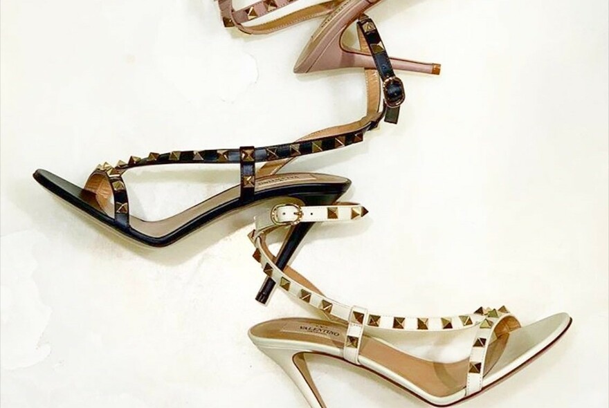 Ladies high-heeled strappy sandals with studs and buckles.