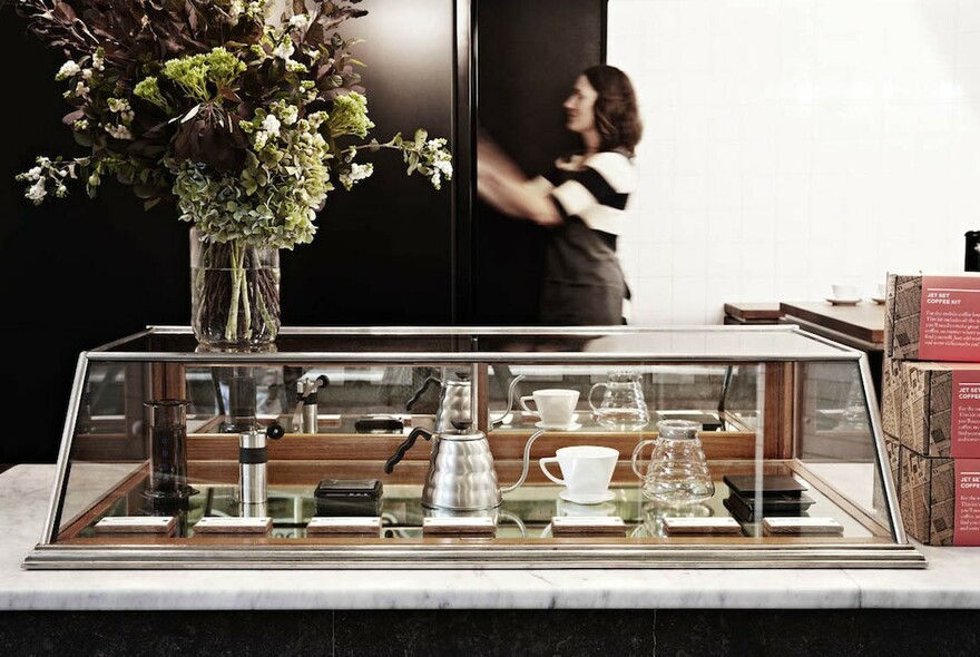 Display cabinet containing coffee-making equipment.