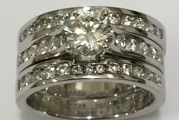 Three band silver ring with diamonds.