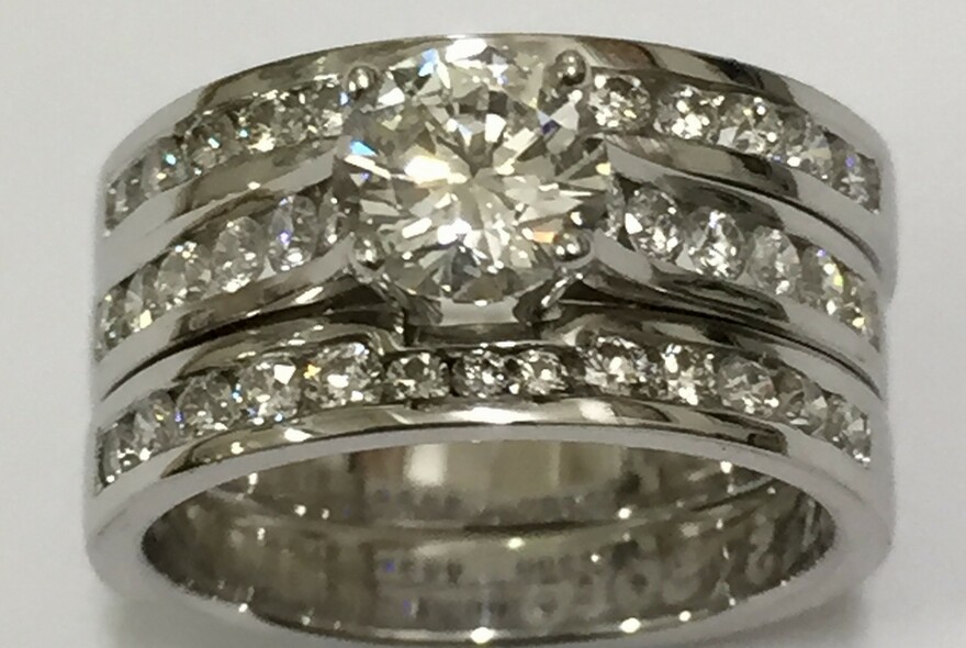Three band silver ring with diamonds.