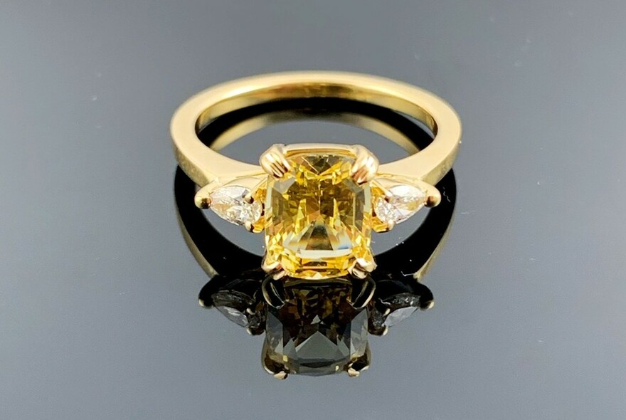 Ring with large yellow stone and diamonds.