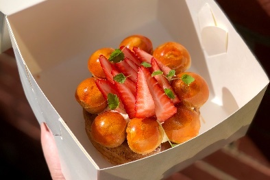 Dessert in a box, topped with strawberries.