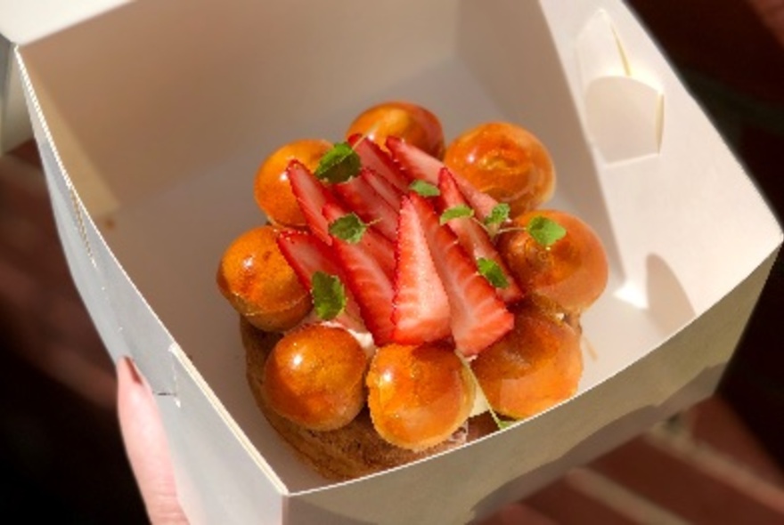 Dessert in a box, topped with strawberries.