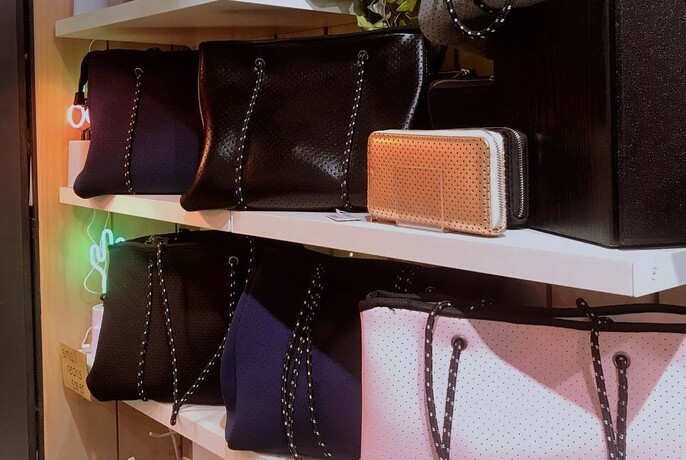 Handbags on two shelves.