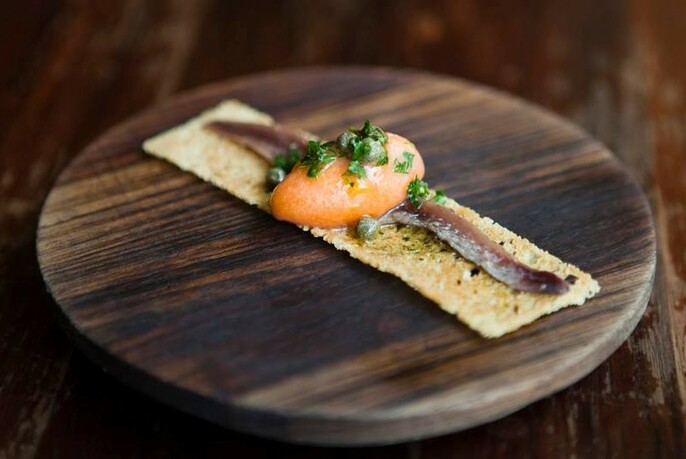 The iconic MoVida tapas - smoked tomato sorbet with anchovy.