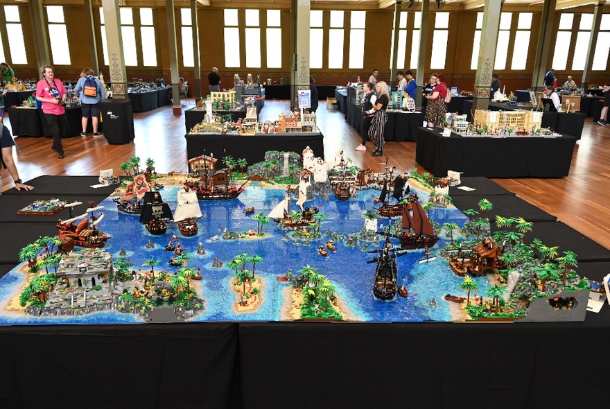 Lego exhibit of the world on display in a large hall with exhibit stalls.