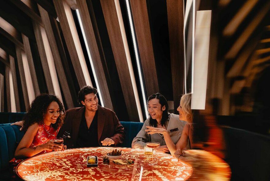 People seated at a round table in a bar with vertical decor.