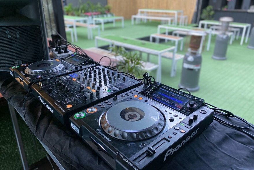 A DJ deck at an empty rooftop bar 