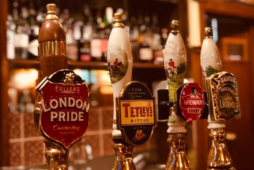 English beer taps in a pub.