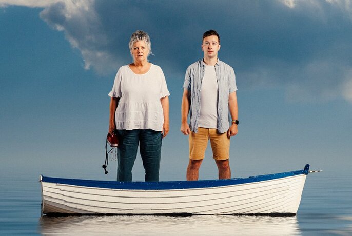 Two people standing in a row boat.