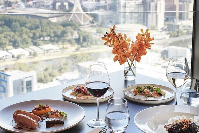 Set table with Melbourne cityscape in background.