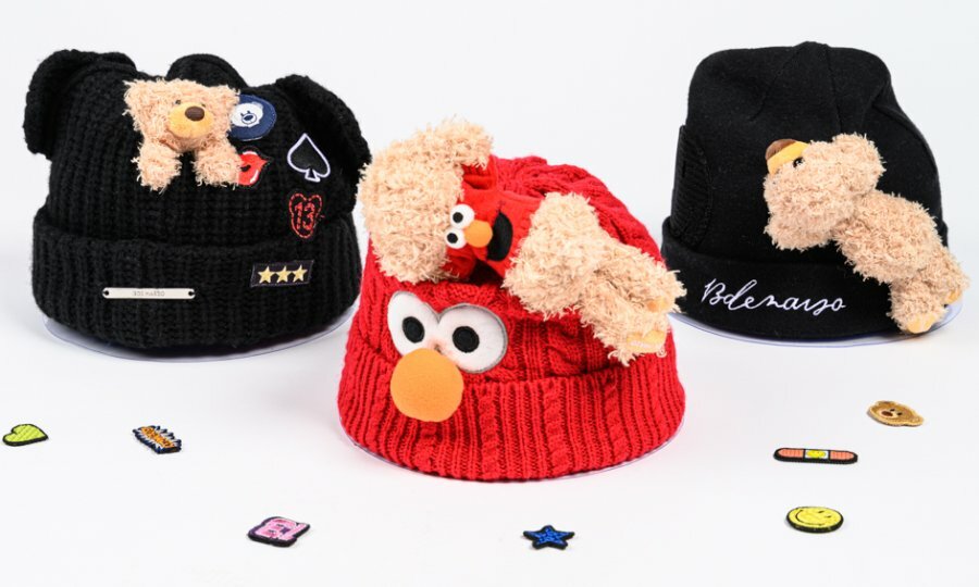 Three beanies with small teddy bears attached, one is an Elmo  beanie.
