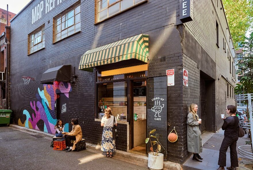 A group of people outside a laneway cafe